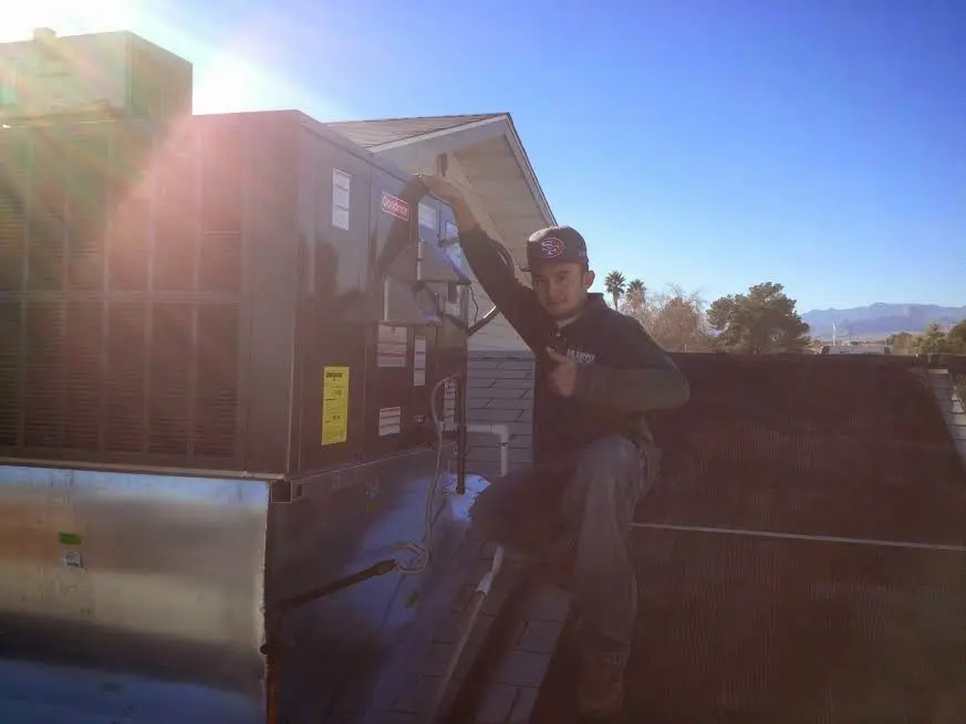 HVAC technician performing AC Tune-Up on a rooftop unit in Bridgewater